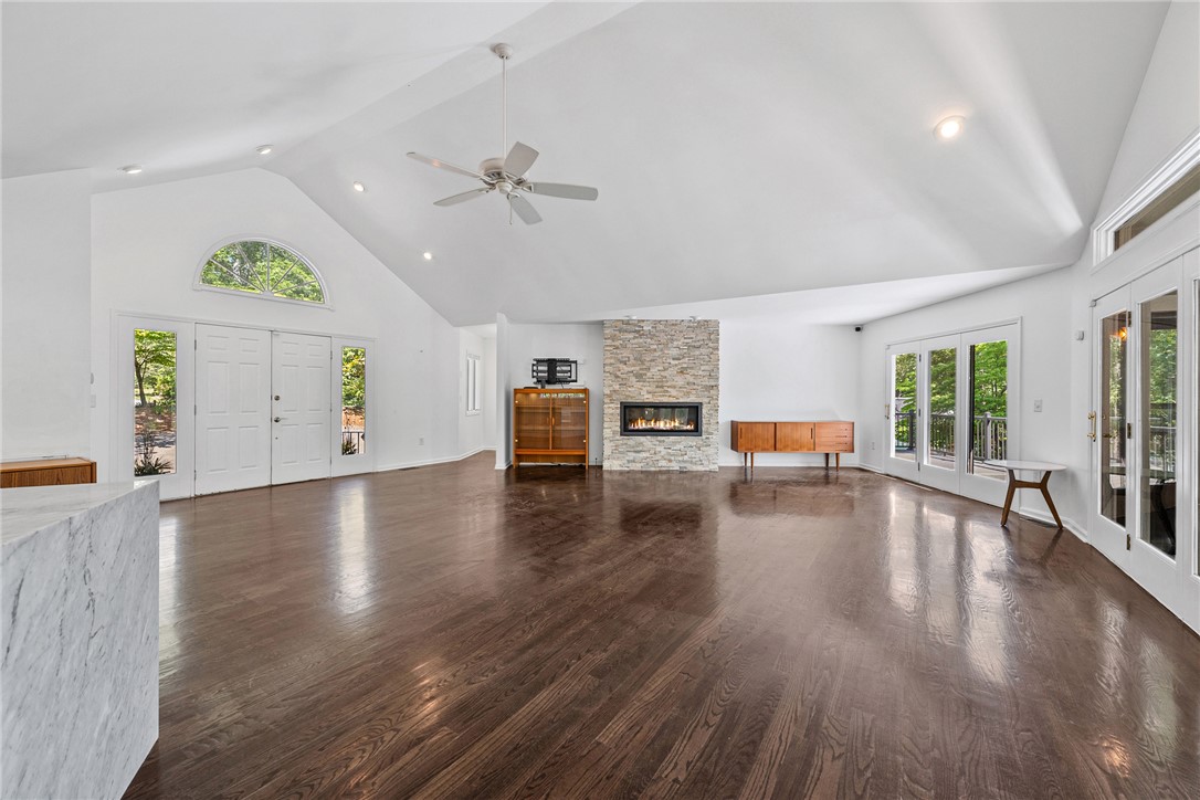 118 Beacon Ridge Circle Salem, SC 29676 - Photo 4 of 45 A spacious living area features rich hardwood floors, a striking stone fireplace, and abundant natural light from large glass doors.