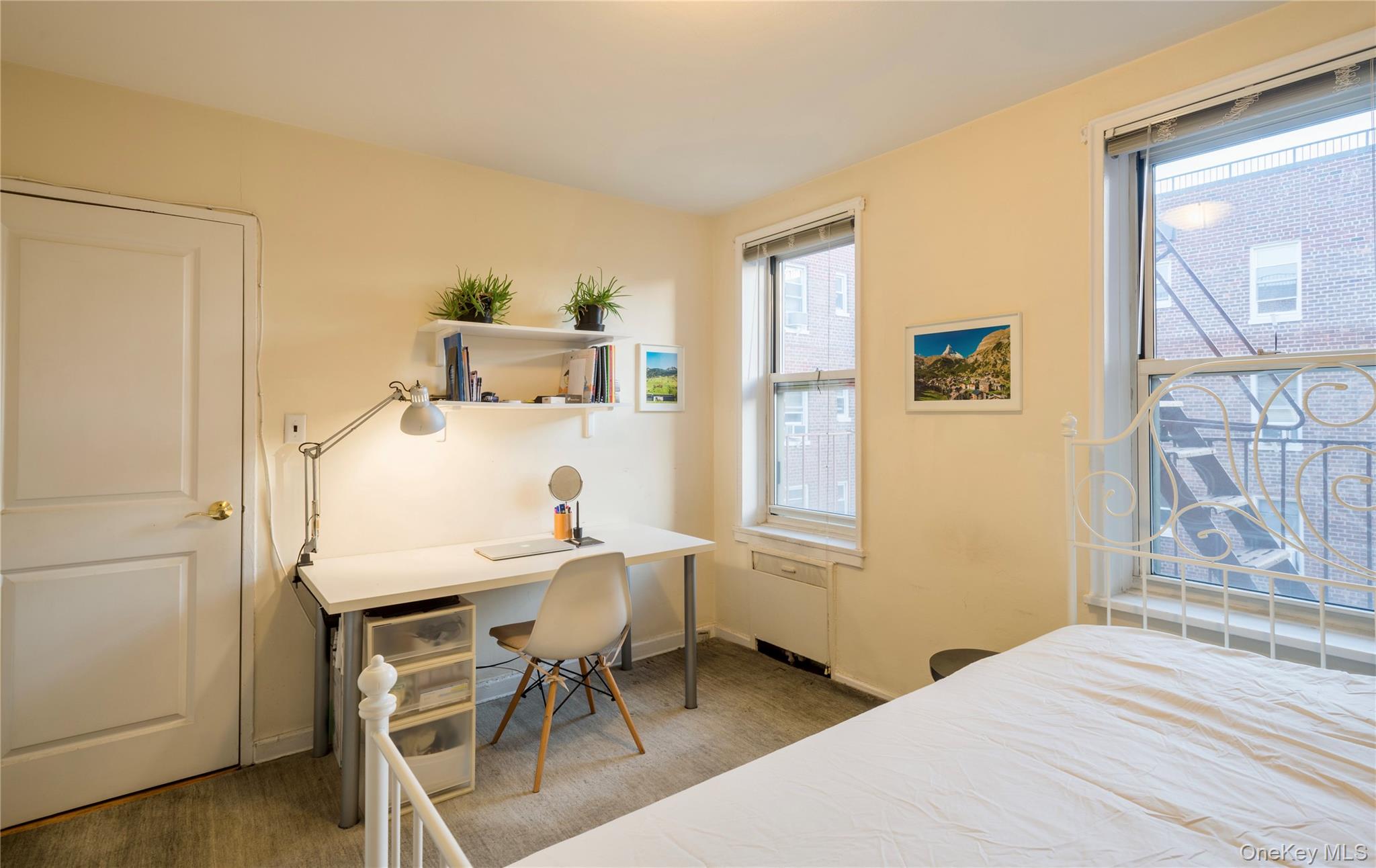 72-61 113th Street, Unit 6C Queens, NY 11375 - Photo 3 of 10 a bedroom with a bed and a table in it