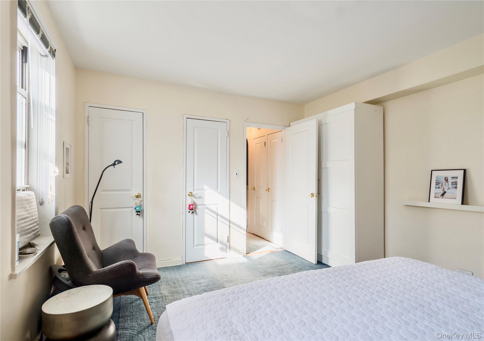 72-61 113th Street, Unit 6C Queens, NY 11375 - Photo 4 of 10 a bedroom with a bed and a couch