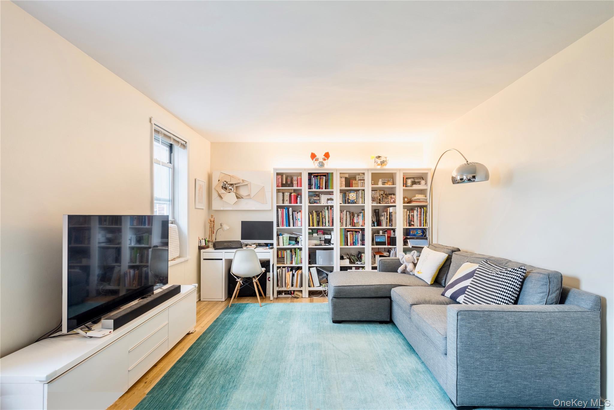 72-61 113th Street, Unit 6C Queens, NY 11375 - Photo 5 of 10 a living room with furniture and a fireplace