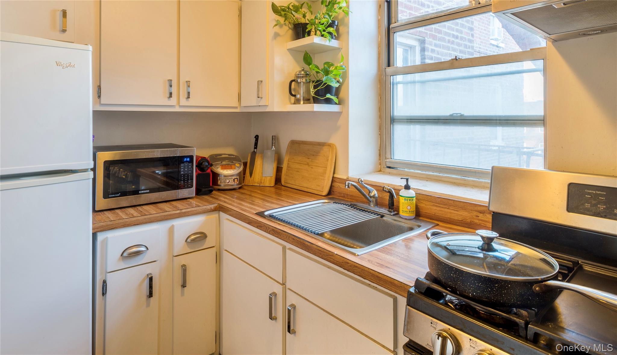 72-61 113th Street, Unit 6C Queens, NY 11375 - Photo 6 of 10 a kitchen with a stove and a sink