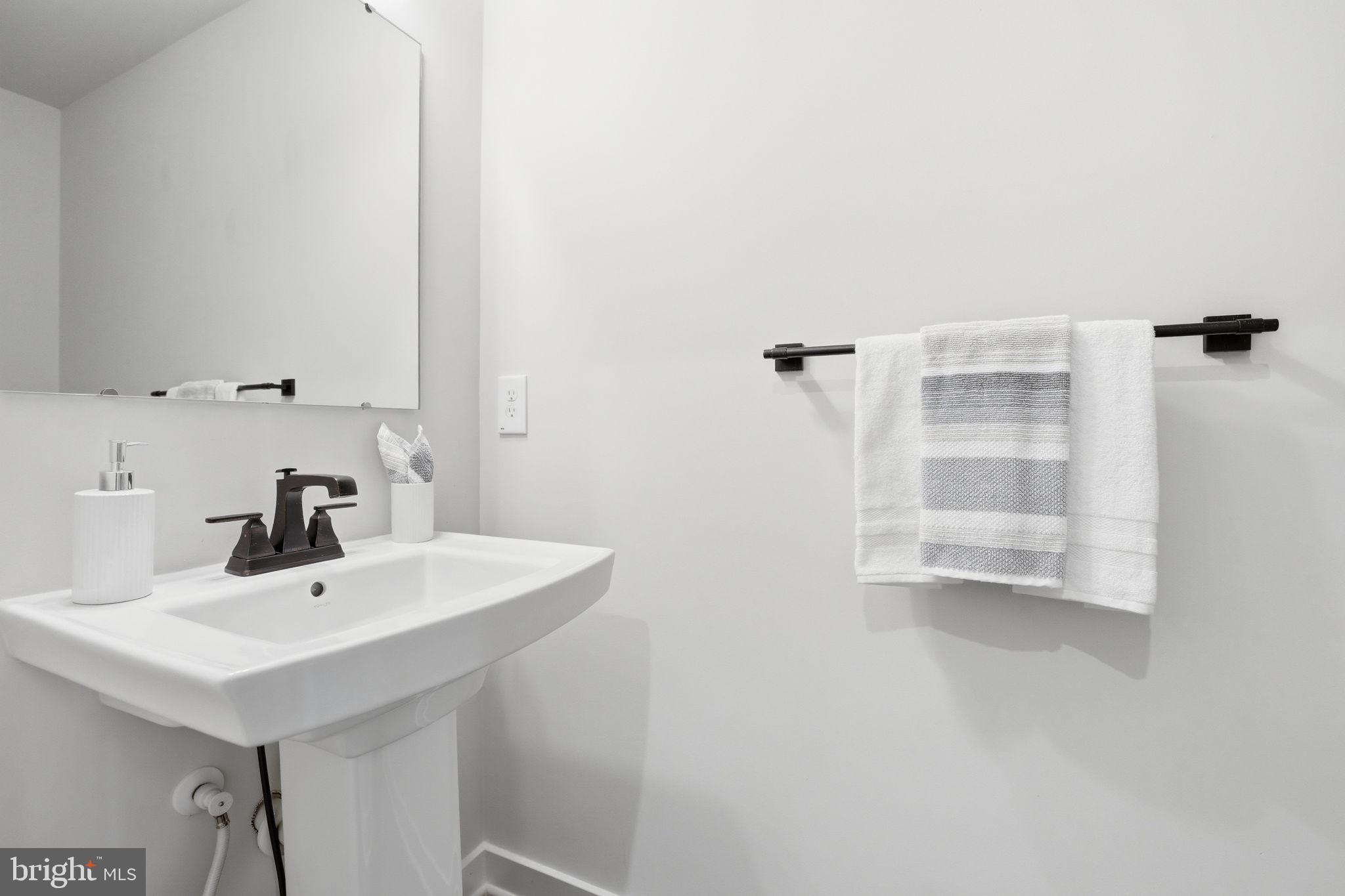 2252 Red Pine Loop Dumfries, VA 22026 - Photo 17 of 117 a bathroom with a sink a mirror and shower