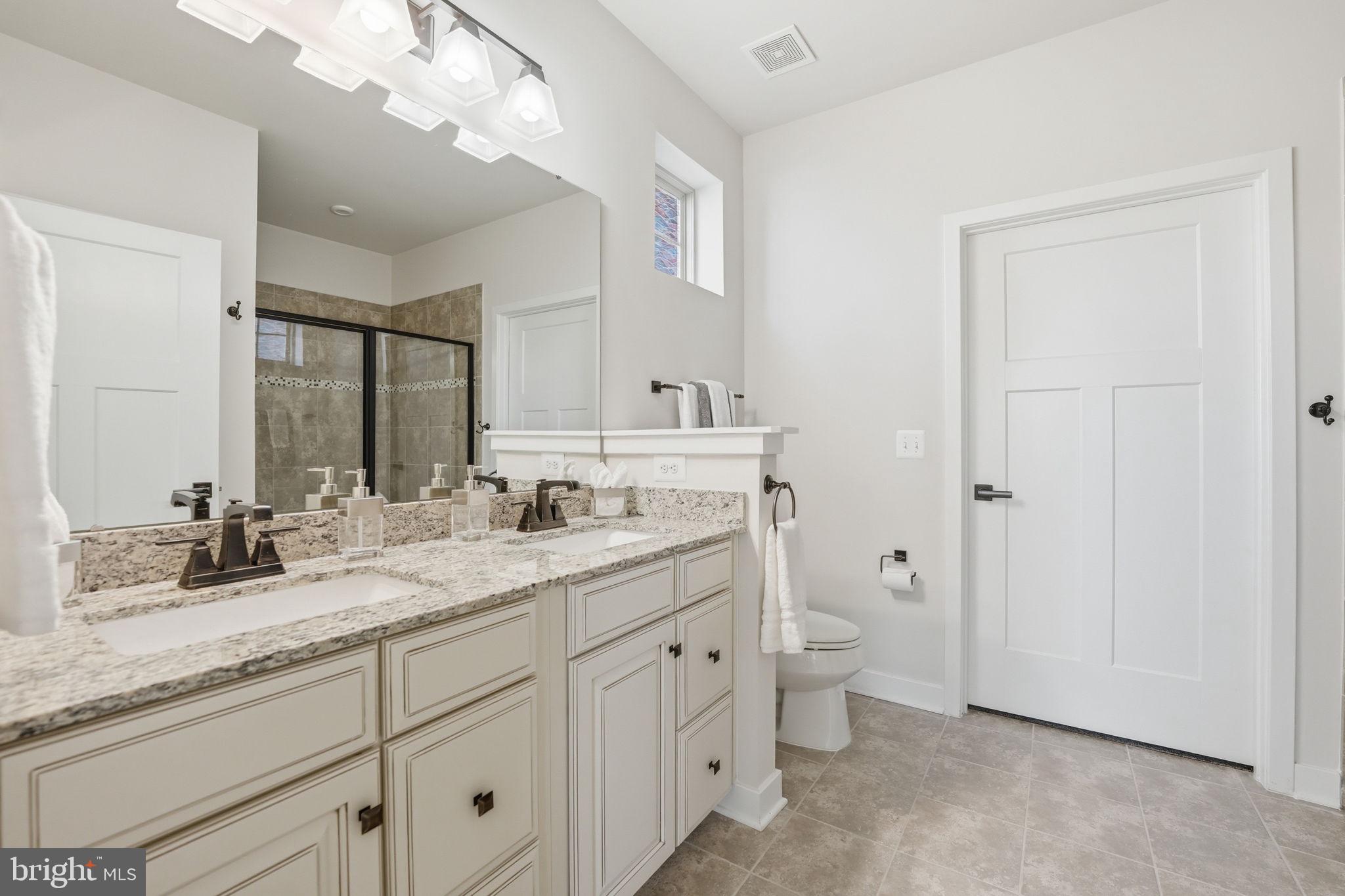 2252 Red Pine Loop Dumfries, VA 22026 - Photo 44 of 117 a bathroom with a granite countertop sink mirror and toilet