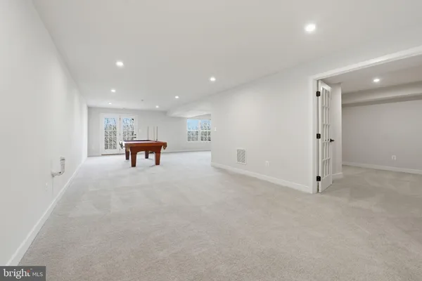 a kitchen with a dining table chairs and large window