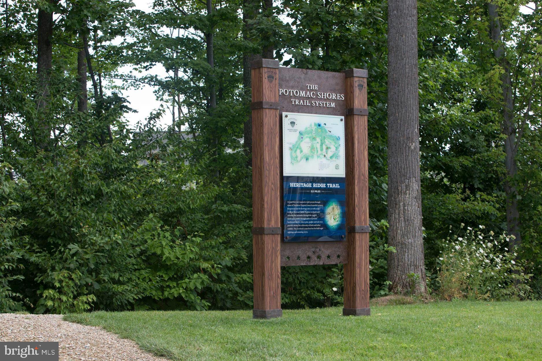 2252 Red Pine Loop Dumfries, VA 22026 - Photo 57 of 117 a sign that is sitting in front of a tree