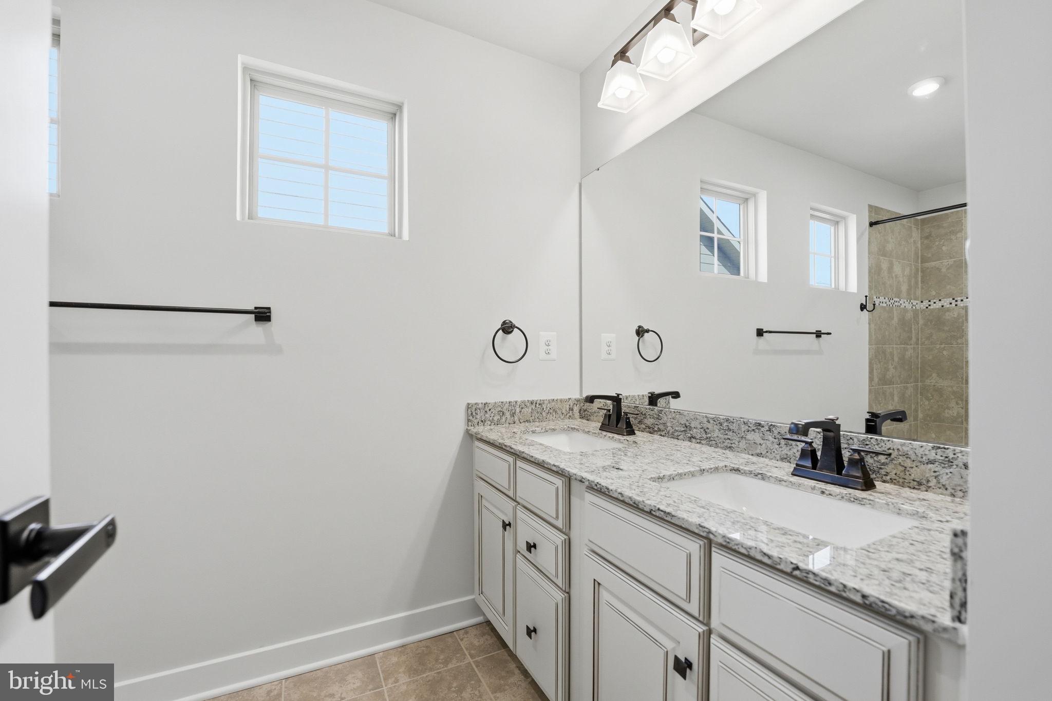 2252 Red Pine Loop Dumfries, VA 22026 - Photo 70 of 117 a bathroom with a granite countertop sink and a mirror