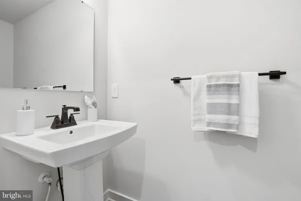 a bathroom with a sink a mirror and shower