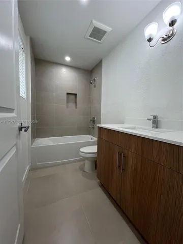 a bathroom with a double vanity sink toilet and shower