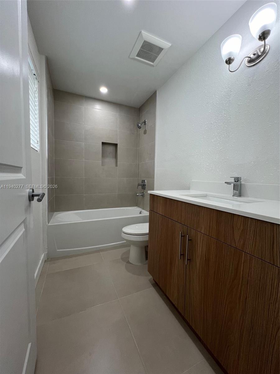 199 Redland Road, Unit A10 Florida City, FL 33034 - Photo 11 of 15 a bathroom with a double vanity sink toilet and shower
