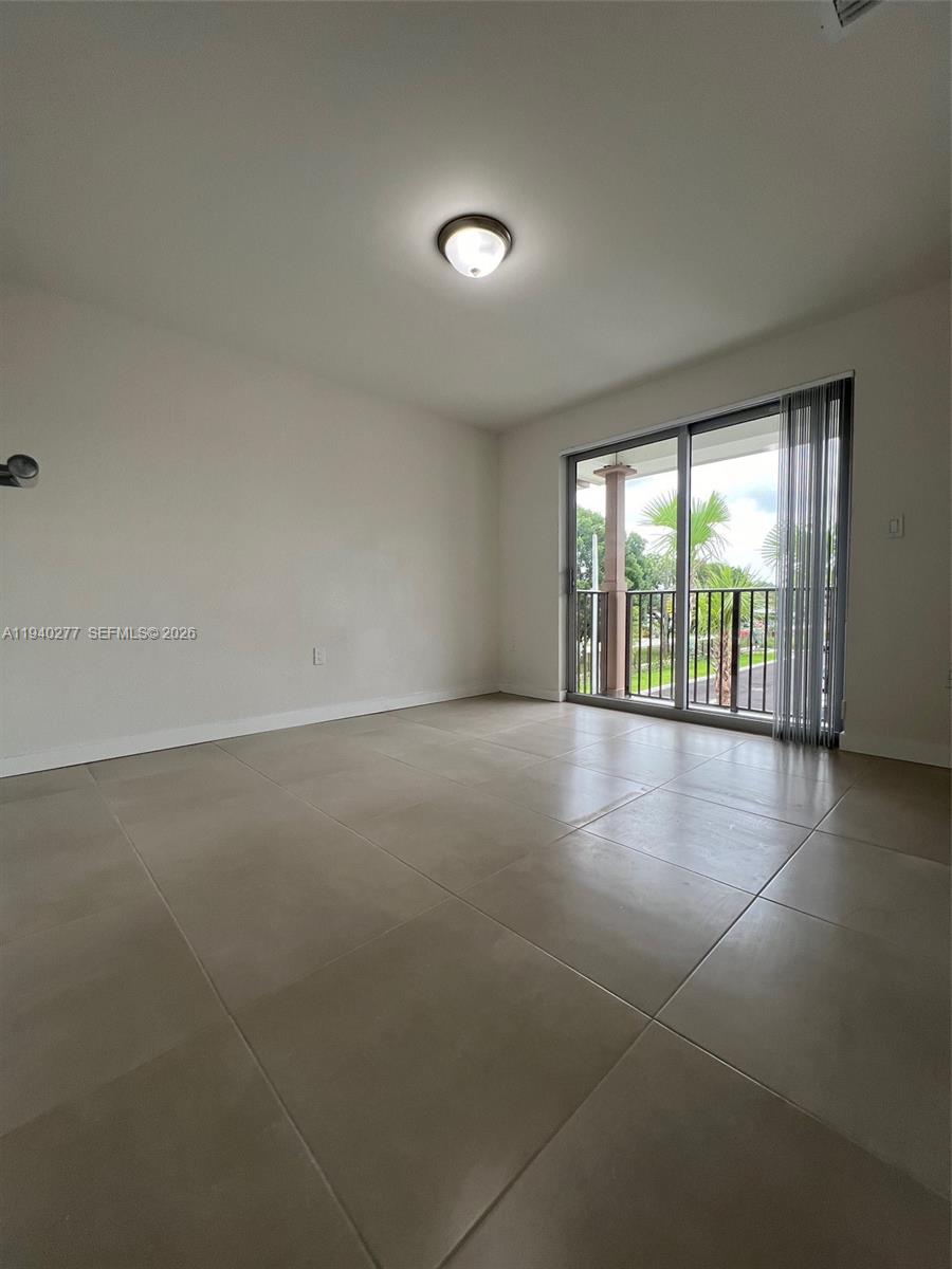 199 Redland Road, Unit A10 Florida City, FL 33034 - Photo 12 of 15 wooden floor in an empty room with a window
