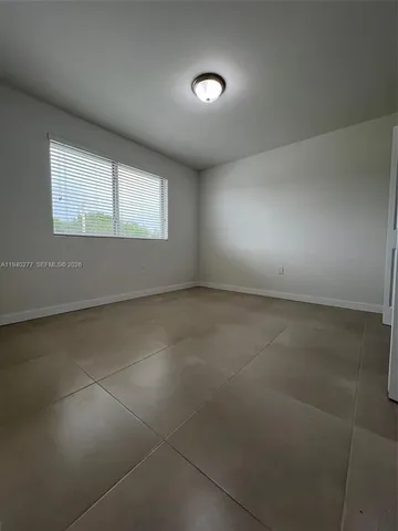 an empty room with a empty space and windows