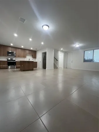 a view of an empty room with a sink