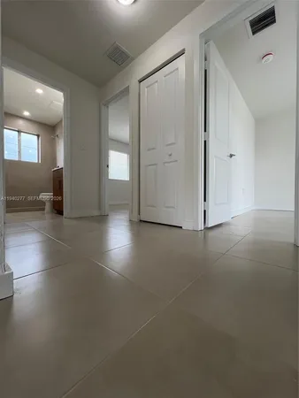 an empty room with windows and entrance