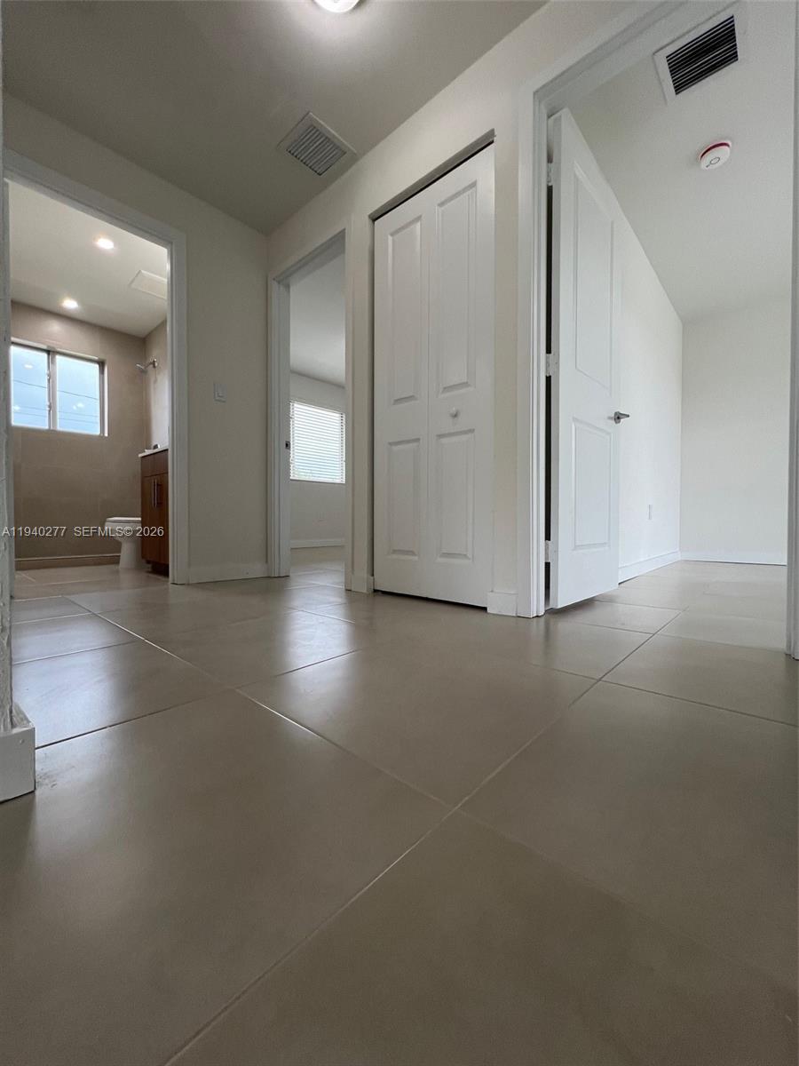 199 Redland Road, Unit A10 Florida City, FL 33034 - Photo 10 of 15 an empty room with windows and entrance