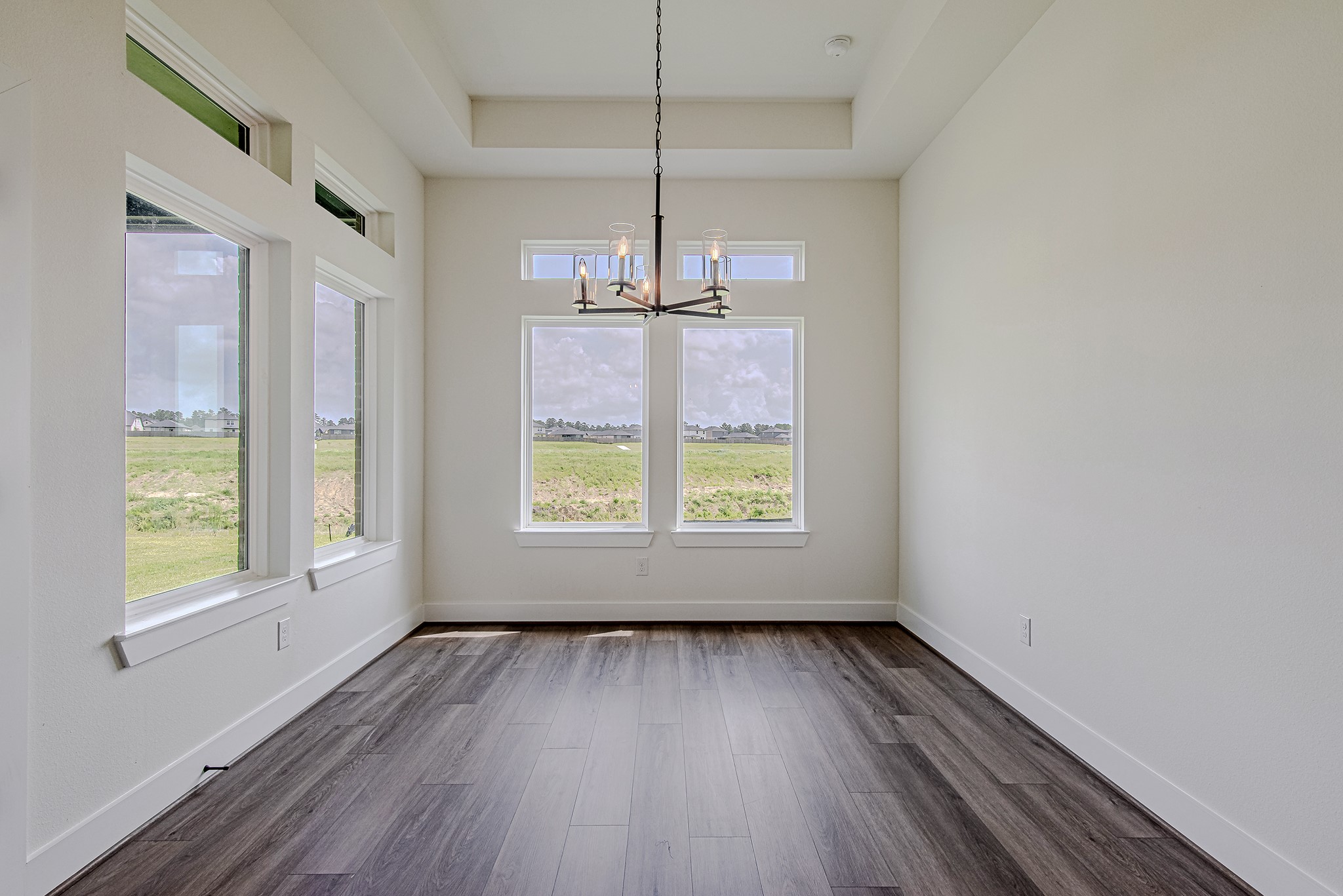 157 Peninsula Point Drive Montgomery, TX 77356 - Photo 10 of 33 a view of an empty room with wooden floor and a window