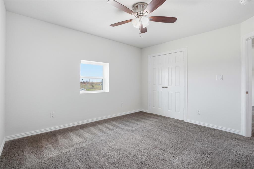 103 West Cleburne Road Crowley, TX 76036 - Photo 11 of 18 an empty room with a window and a fan