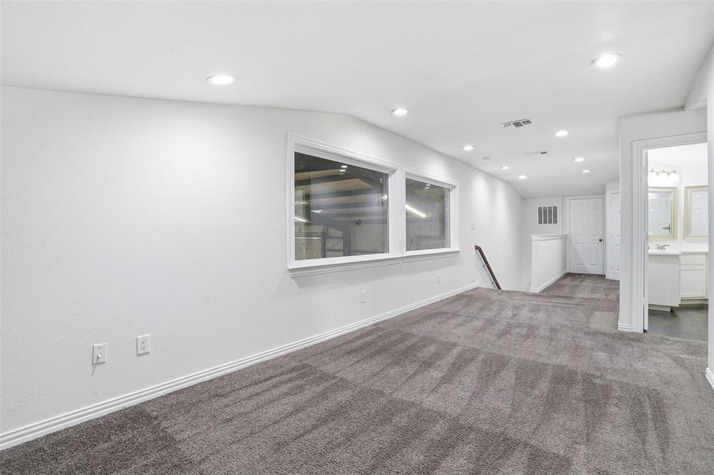 103 West Cleburne Road Crowley, TX 76036 - Photo 13 of 18 an empty room with wooden floor and windows