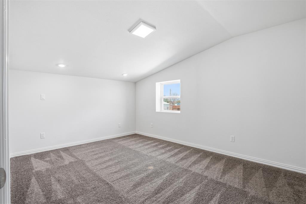 103 West Cleburne Road Crowley, TX 76036 - Photo 16 of 18 an empty room with a empty space and a window