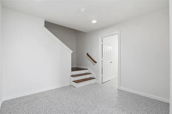 a view of an empty room with stairs