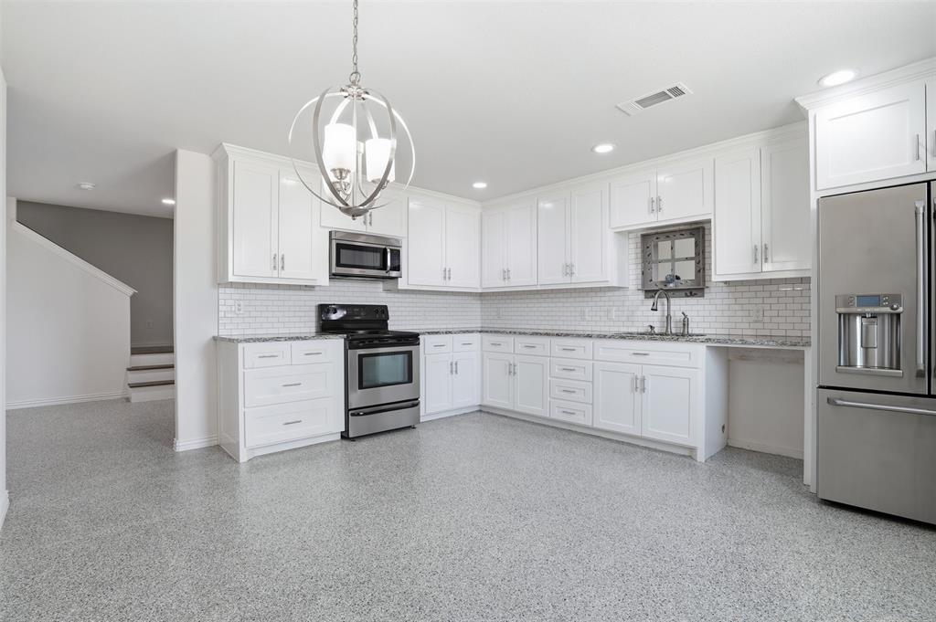 103 West Cleburne Road Crowley, TX 76036 - Photo 4 of 18 a kitchen with stainless steel appliances granite countertop a stove a sink a refrigerator and a microwave