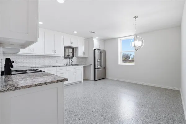 a kitchen with refrigerator and window