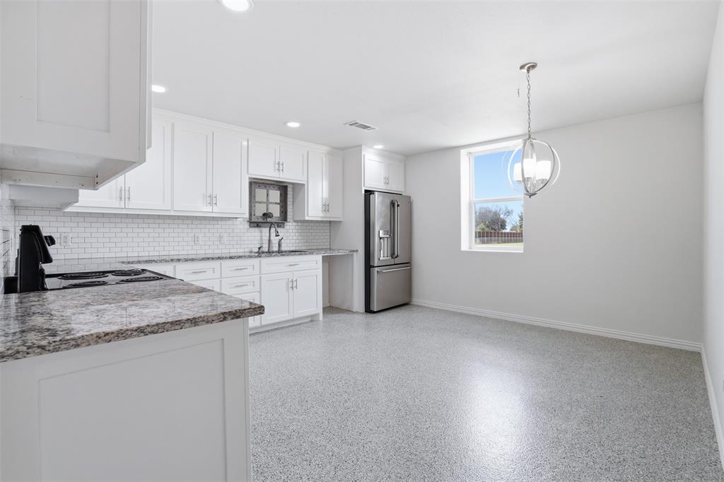 103 West Cleburne Road Crowley, TX 76036 - Photo 6 of 18 a kitchen with refrigerator and window
