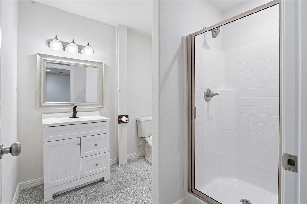 103 West Cleburne Road Crowley, TX 76036 - Photo 7 of 18 a bathroom with a sink a mirror and a shower
