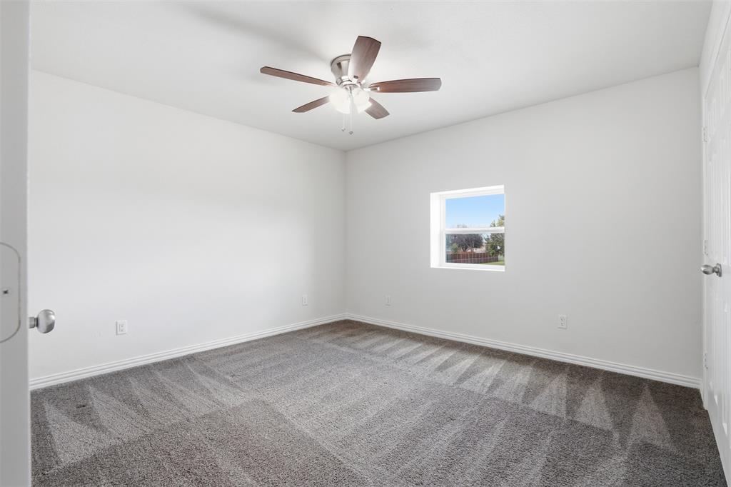 103 West Cleburne Road Crowley, TX 76036 - Photo 10 of 18 an empty room with ceiling fan and window