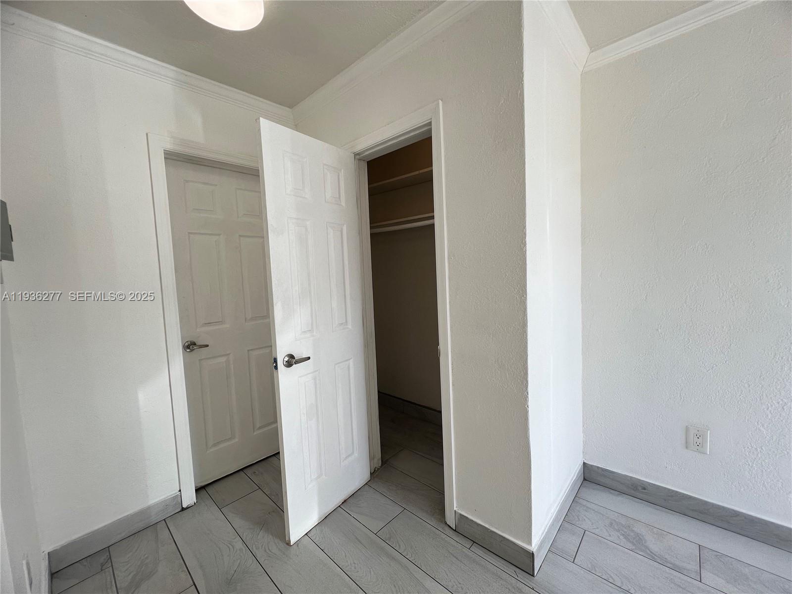 159 Northeast 75th Street, Unit 1 Miami, FL 33138 - Photo 7 of 8 a view of an empty room with wooden door