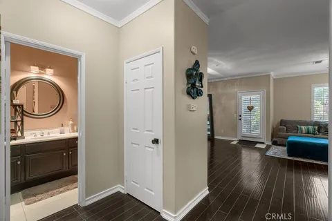 a view of a dining room with furniture a chandelier and wooden floor