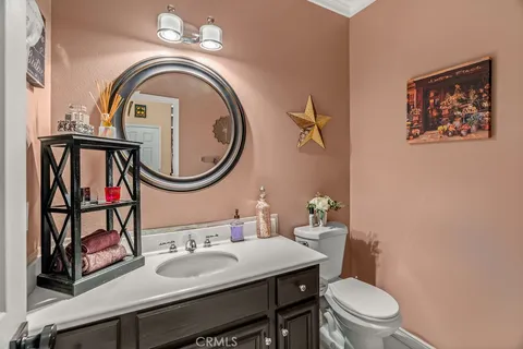 a dining room with furniture a chandelier and wooden floor