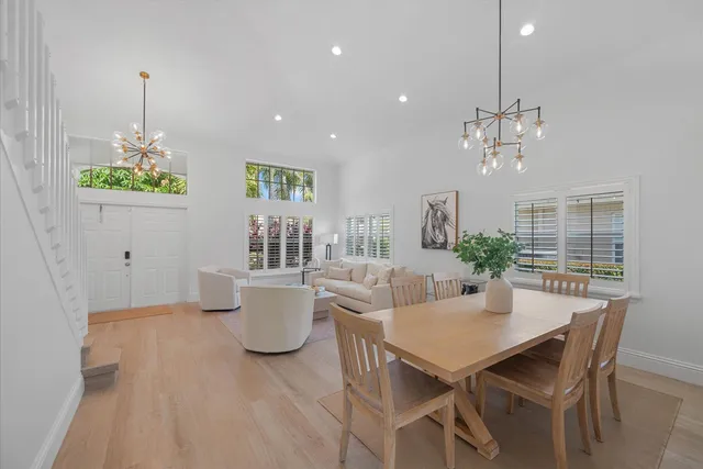 a view of a dining room with furniture and chandelier