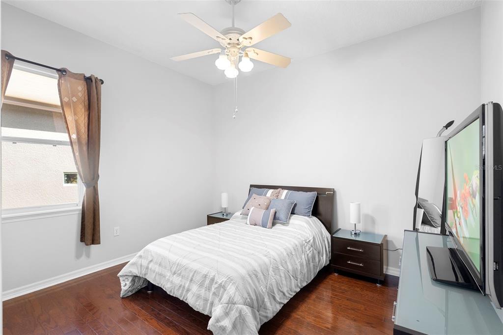 440 Sotheby Way DeBary, FL 32713 - Photo 12 of 37 a bedroom with a bed and a flat tv screen on a dresser