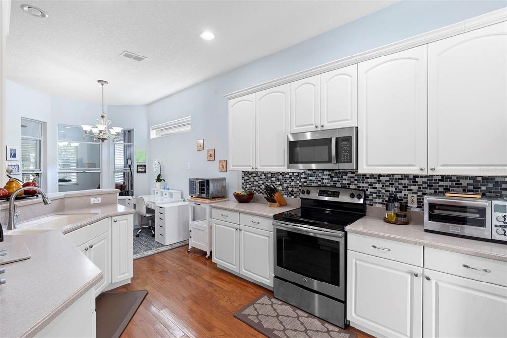 440 Sotheby Way DeBary, FL 32713 - Photo 14 of 37 a kitchen with a sink stove and microwave