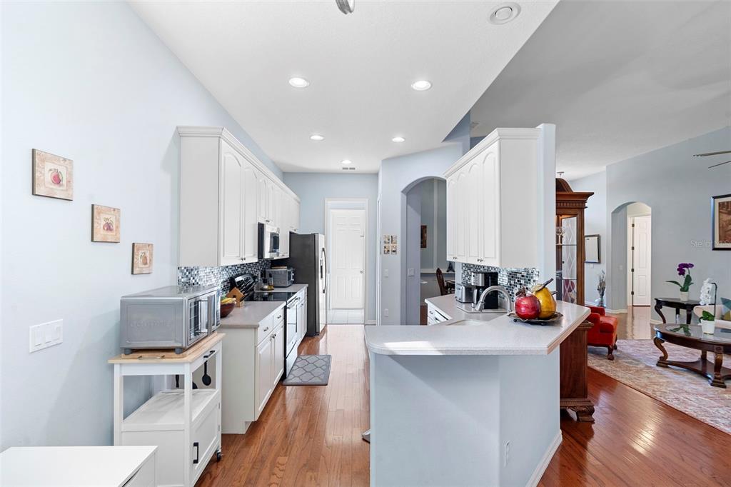 440 Sotheby Way DeBary, FL 32713 - Photo 16 of 37 a kitchen with sink refrigerator and cabinets