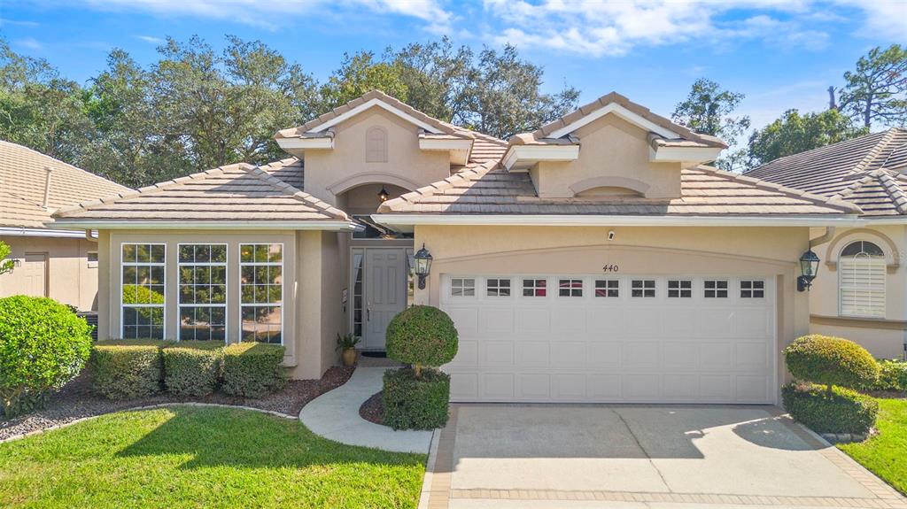 440 Sotheby Way DeBary, FL 32713 - Photo 2 of 37 a front view of a house with garden