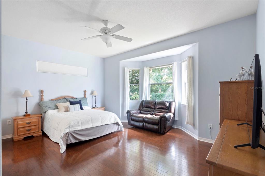 440 Sotheby Way DeBary, FL 32713 - Photo 22 of 37 a bedroom with a bed couch and a window