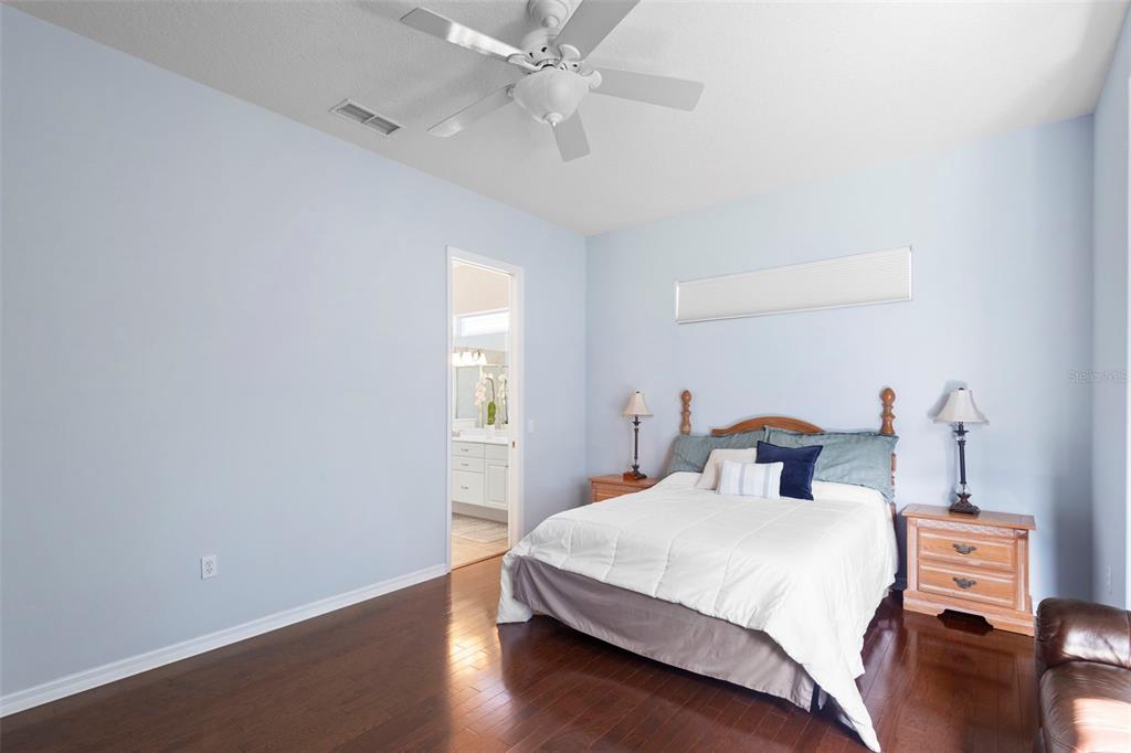 440 Sotheby Way DeBary, FL 32713 - Photo 23 of 37 a bedroom with a bed and wooden floor