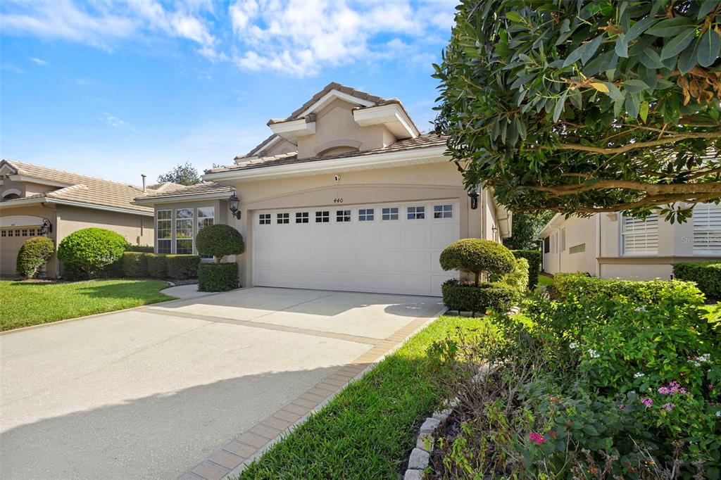 440 Sotheby Way DeBary, FL 32713 - Photo 4 of 37 a front view of a house with a yard and garage