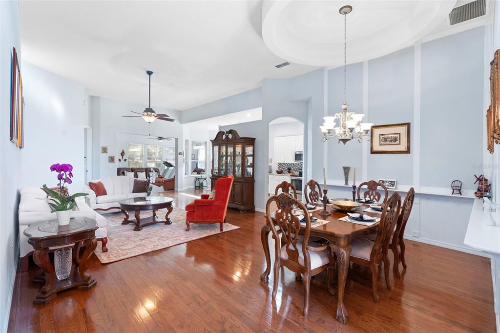440 Sotheby Way DeBary, FL 32713 - Photo 7 of 37 a view of a dining room with furniture wooden floor and chandelier