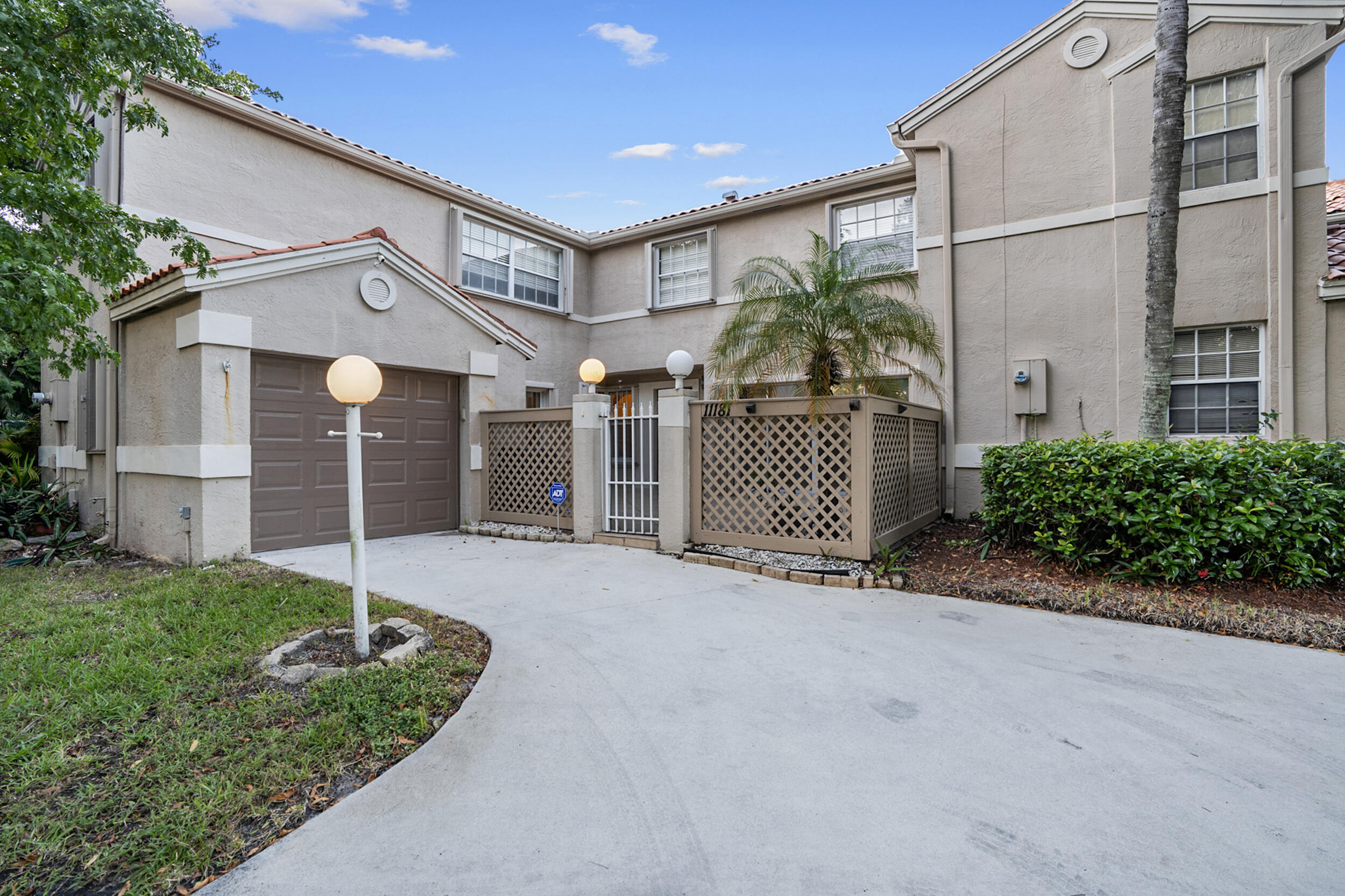 a view of a house with a small yard and plants