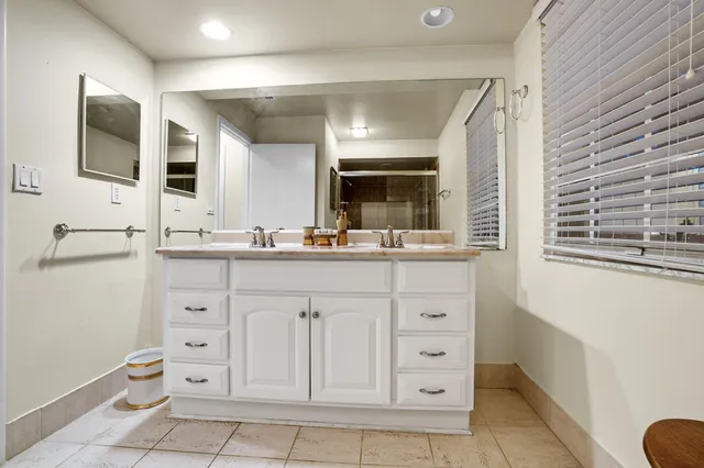 a bathroom with a double vanity sink mirror and toilet