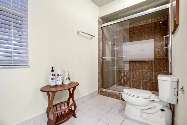 a bathroom with a toilet and a shower