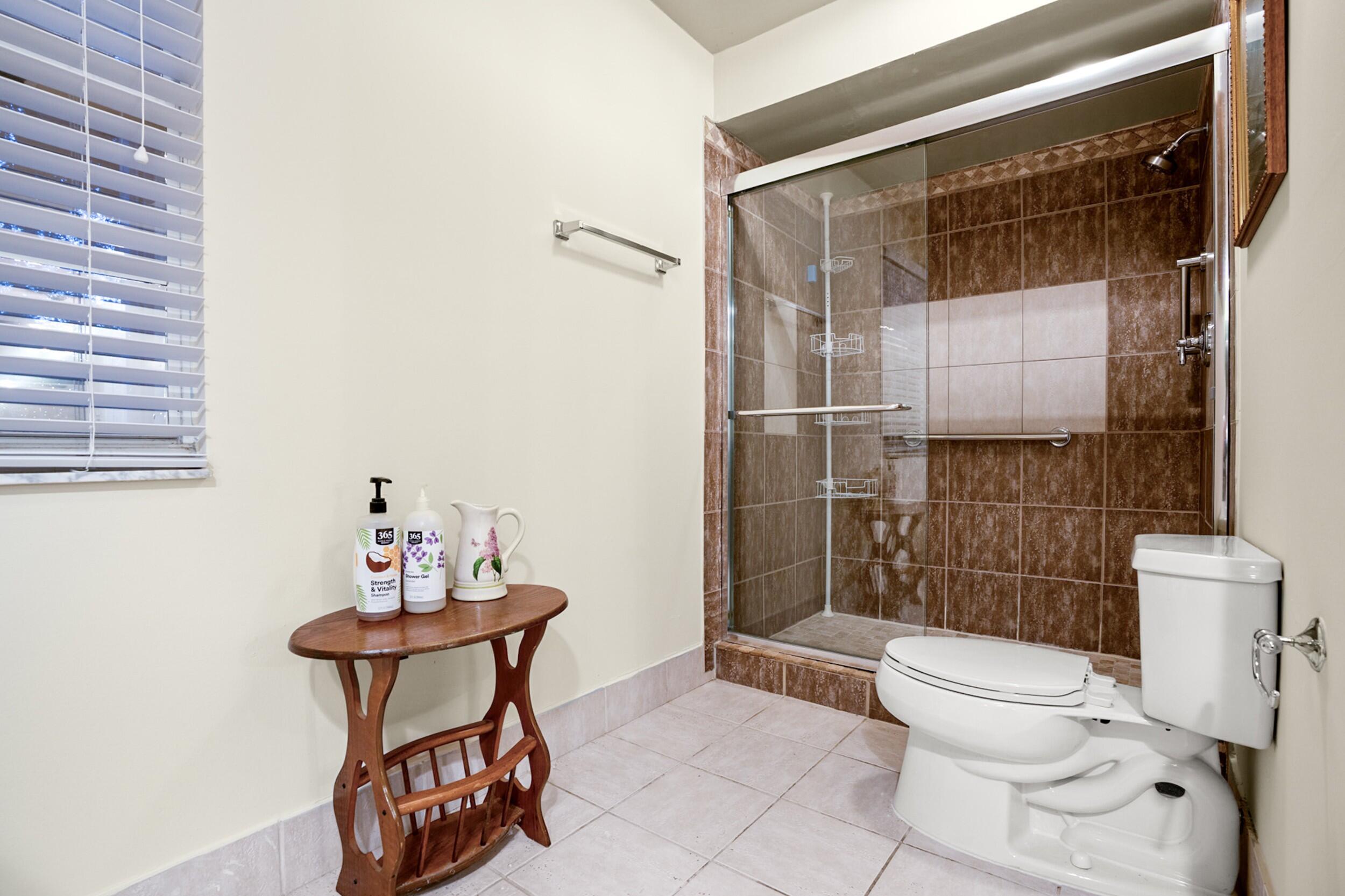 11181 Nautilus Drive Cooper City, FL 33026 - Photo 13 of 16 a bathroom with a toilet and a shower