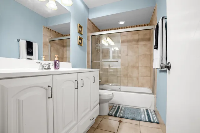 a bathroom with a sink mirror vanity and toilet