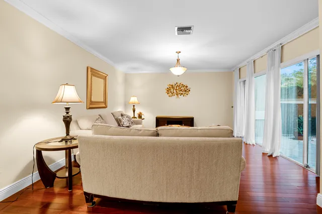 a view of a livingroom with furniture window and wooden floor