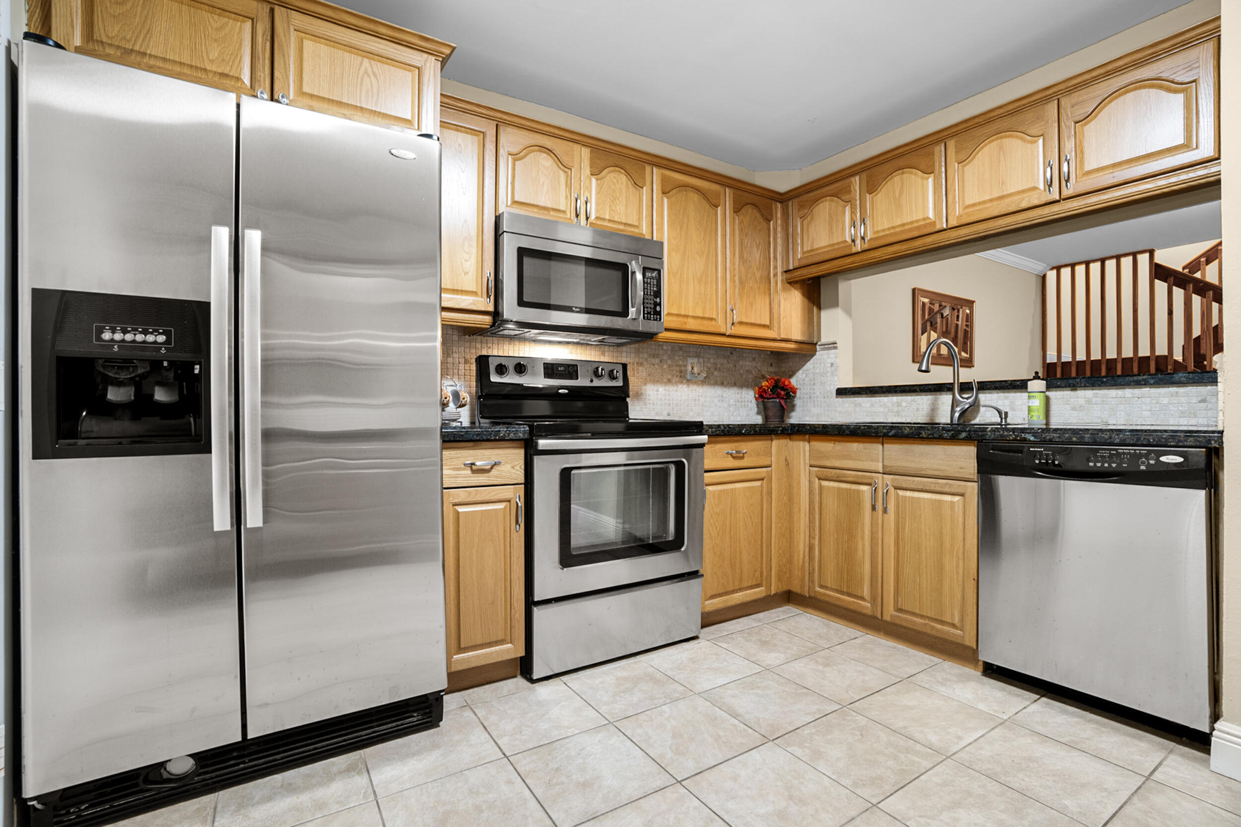 11181 Nautilus Drive Cooper City, FL 33026 - Photo 6 of 16 a kitchen with stainless steel appliances granite countertop a refrigerator a stove a sink and dishwasher