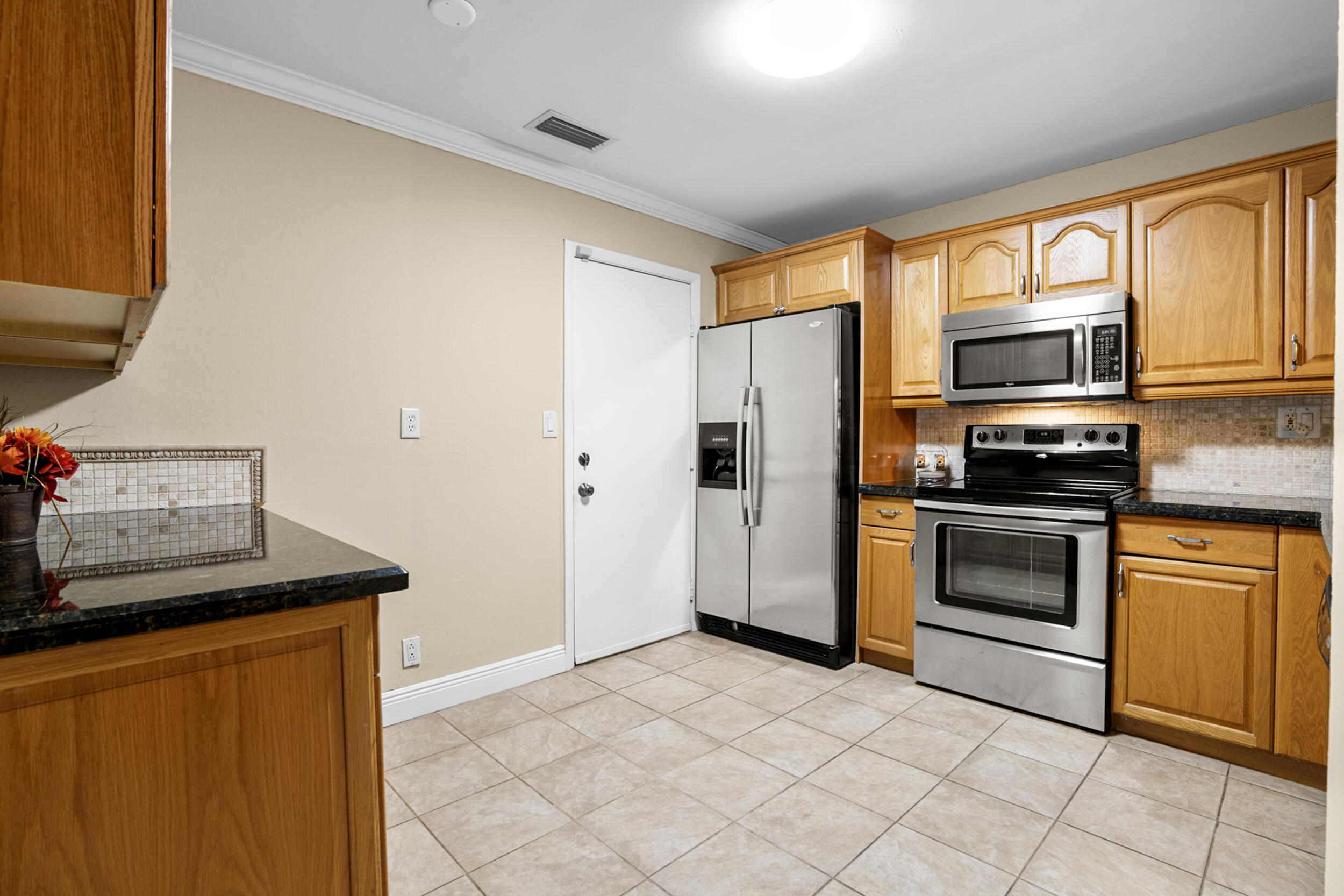 11181 Nautilus Drive Cooper City, FL 33026 - Photo 7 of 16 a kitchen with stainless steel appliances granite countertop a stove a sink and a refrigerator
