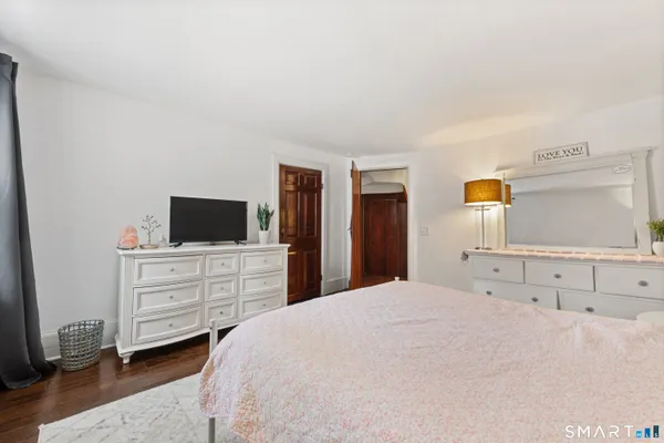 a bedroom with a large bed and a window