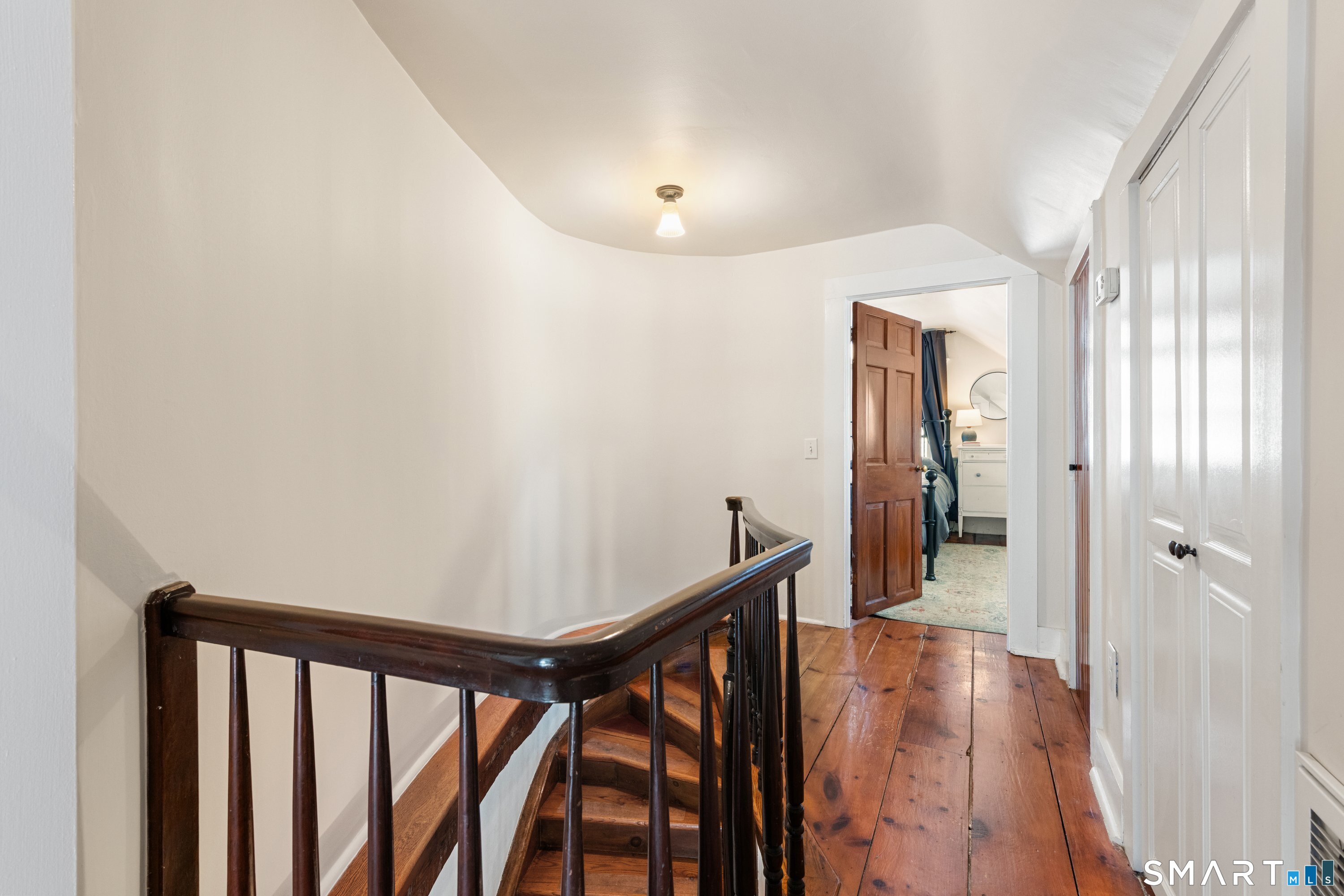 138 Putnam Park Road Bethel, CT 06801 - Photo 32 of 40 a view of a hallway with wooden floor and staircase